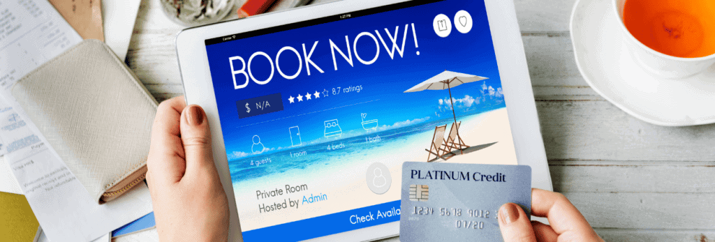 Customer making a booking on a tablet while holding a credit card