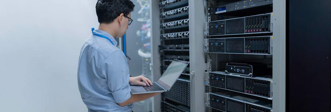 IT staff is setting up network in server room systems maintenance