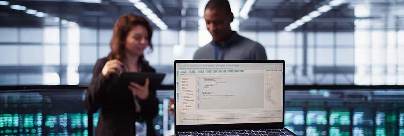Close-up of programming language on notebook used by server room IT experts
