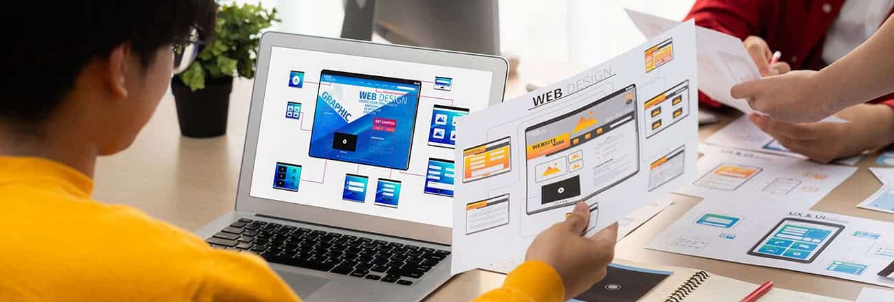 UIUX designer designing website with software display on laptop