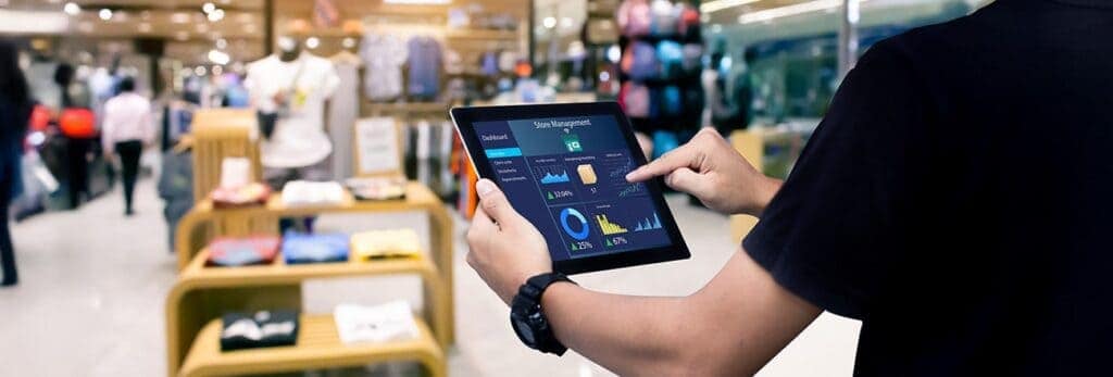 Retail staff checking inventory stock on tablet