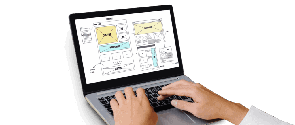 Hands typing on a laptop showing website wireframe mockups